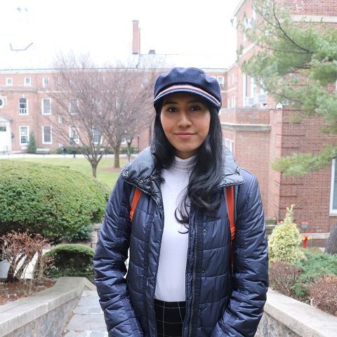 lily with navy blue hat and jacket standing for picture